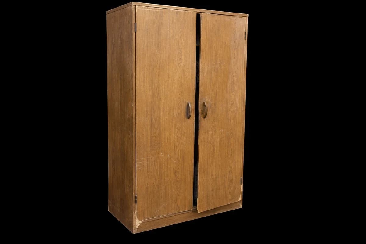 Old two-door wardrobe Old two-door wardrobe with chipped corners and a misaligned door.